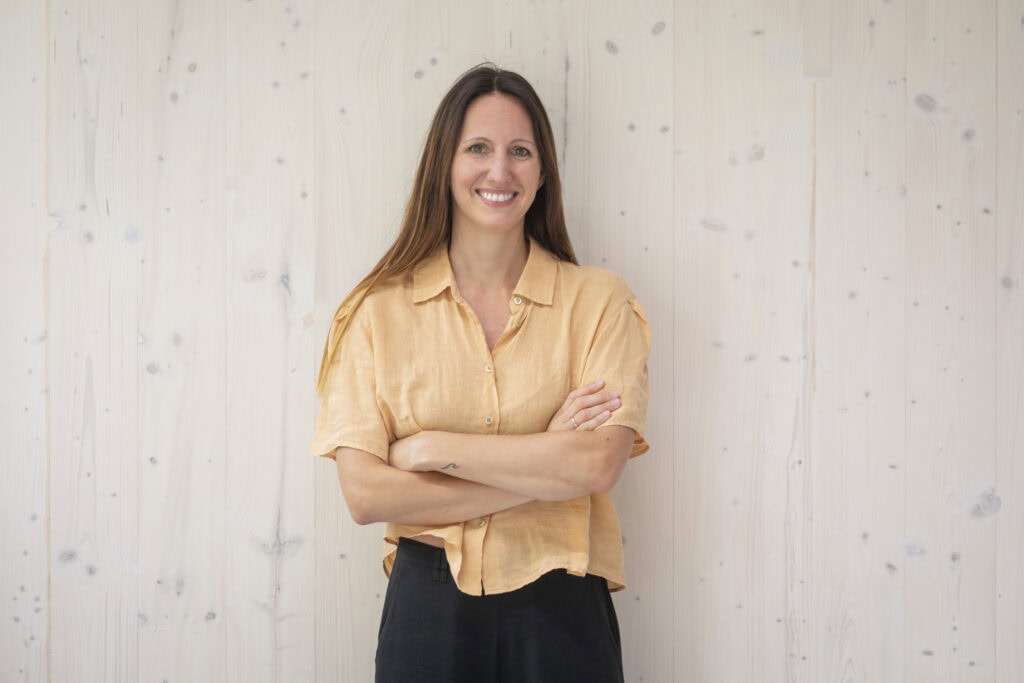 Home 14 Tatiana, founder of Schola Vera, standing in front of you and smiling.