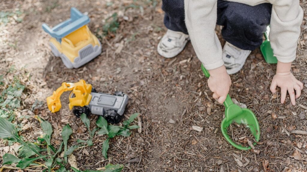 Montessori, Waldorf, or Something Different? A Parent's Guide to Educational Choices 3 A child playing with toys in the forest.