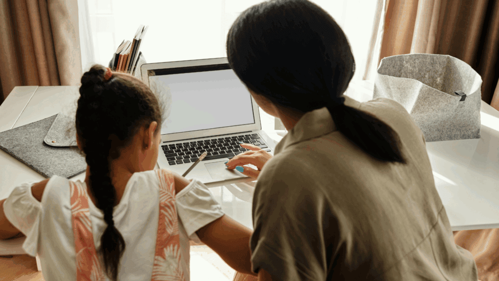 4 Traditional Schooling Alternatives: Homeschooling, Unschooling, Online Schooling, or something better? A Parent’s Guide. 2 Homeschooling: A mother and her child working on a laptop.