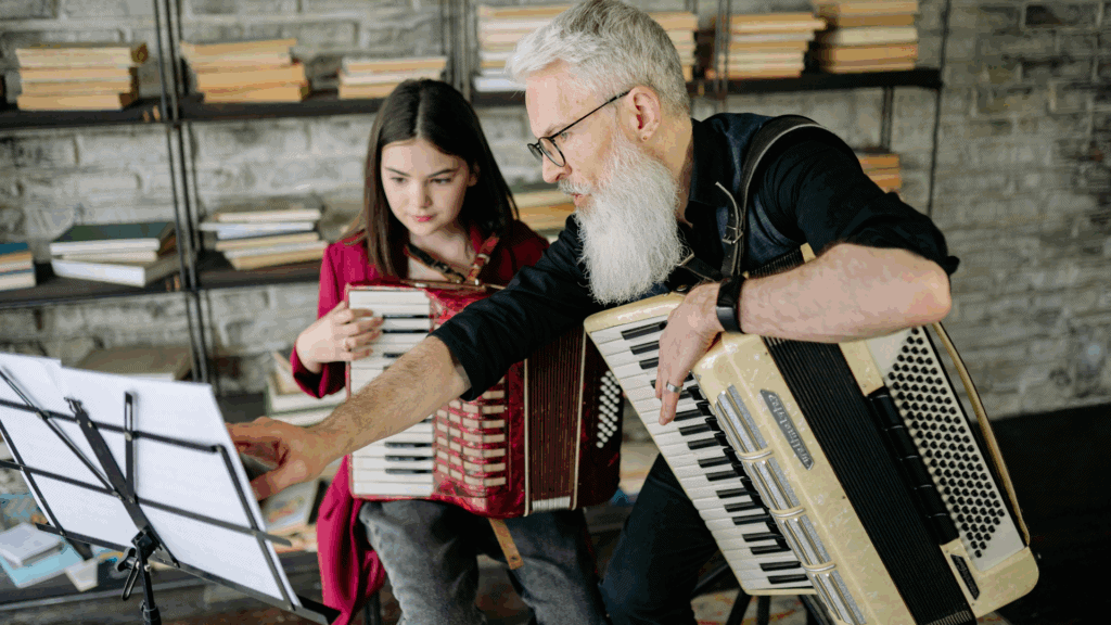 4 Traditional Schooling Alternatives: Homeschooling, Unschooling, Online Schooling, or something better? A Parent’s Guide. 4 Unschooling: An older man and a young girl playing an accordion.