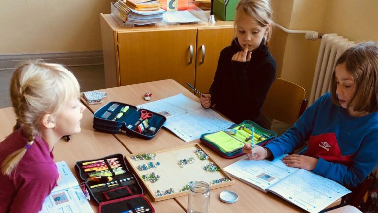 Kids in the classroom working on a math problem in the open morning ritual