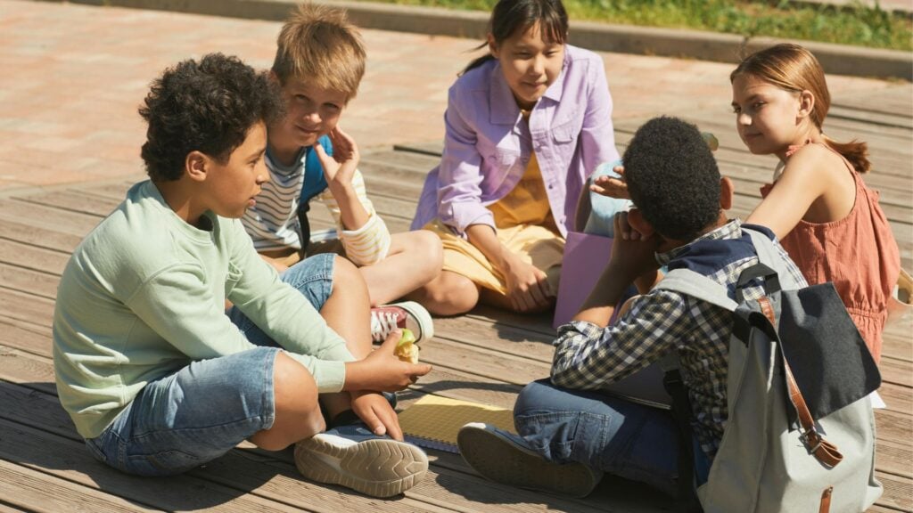Giraffe or Wolf Language? How We Help Children Speak From the Heart 3 A group of kids are speaking while they sit in a circle